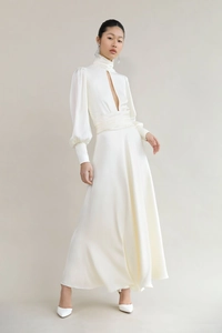 Detail of elegant ivory satin gown featuring high neck, cut-out chest, and lantern sleeves