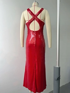 Detail of red sequin evening gown featuring a criss-cross backless design and high slit