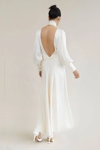 Detailed back view of backless satin maxi dress with high neck and elegant long sleeves