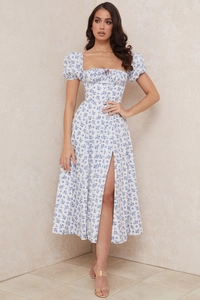 Detail view of square neckline with lace-up tie and puff sleeves on floral dress