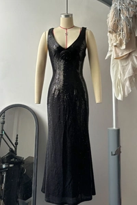 Close-up of black sequin evening dress featuring 3D rose detail and deep V-neckline