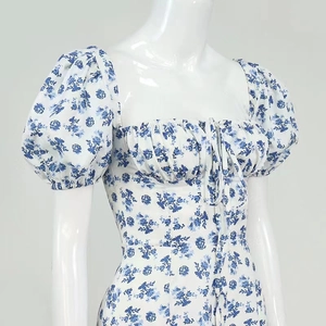 Close-up of square neck detail with drawstring and blue floral puff sleeves on a dress
