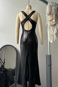 Detail of sexy backless sequin evening dress with criss-cross straps and back slit