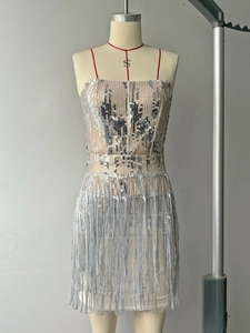 Detail shot of silver sequins and cascading tassels on a sparkling party dress