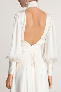 Detailed back view of an elegant backless ivory satin dress with tie-up waist and lantern sleeves