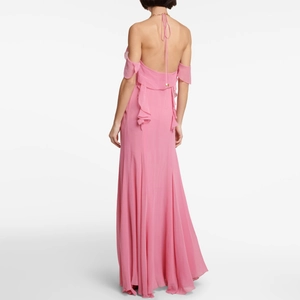 Pink halter backless maxi dress with ruffle detailing and floor-length flowing silhouette