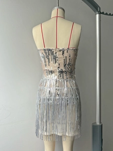 Detailed view of silver sequin party dress with long tassels and thin shoulder straps