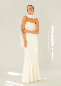 Detail of elegant cream halter fishtail maxi dress with textured pleats and matching scarf