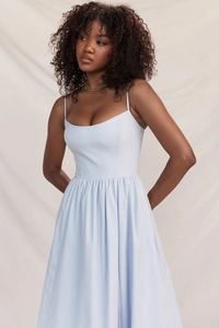 Detail of light blue sleeveless A-line dress featuring high waist pleats and thin straps