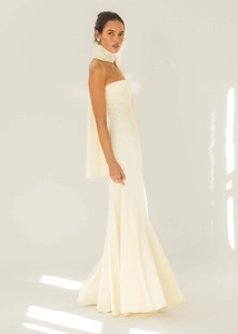 Detail of elegant cream off-the-shoulder maxi dress with vertical pleated fabric texture