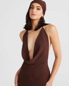 Detail of deep V-neckline on brown satin halter dress with matching headscarf