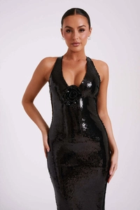 Detail of black sequined evening dress featuring a deep V-neck and handcrafted floral motif