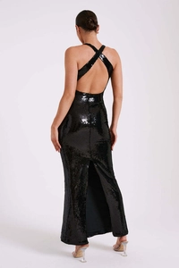 Detail of elegant backless black sequin dress with crossover halter neck and high slit