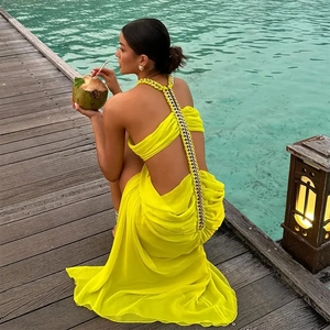Vibrant yellow chiffon maxi dress with gold chain backless detail for beach vacation wear