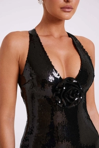 Close-up of black sequined evening dress featuring a handcrafted 3D rose and deep V-neckline