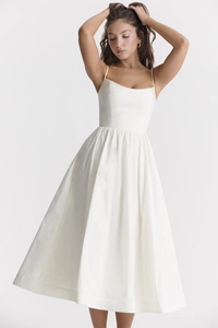 Detail of a white midi dress with thin straps, square neckline and pleated waist design