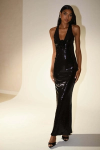Detailed close-up of 3D sequin flower and shimmering fabric on a black evening gown