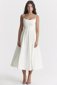 Close-up of white midi dress showing thin straps and elegant curved square neckline detail