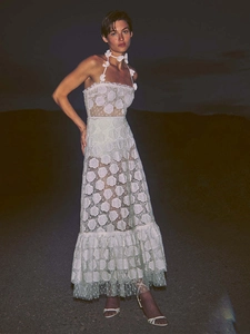 Detail of white lace halter dress showing 3D floral accents and rose embroidery