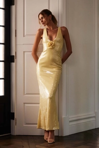 Detailed view of yellow sequin maxi dress featuring a 3D floral accent and V-neckline