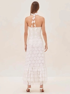 Detail of elegant white lace dress showing halter neck with 3D floral applique and open back