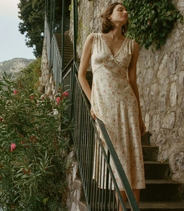 Detail of French V-neck floral midi dress with delicate ruffle trim and lace accents