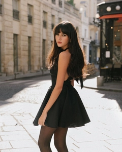 Macro shot of a backless black dress with halter neck and bow tie detail