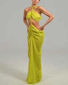 Detail of lime green halter neck evening dress with decorative chain and ruched chiffon skirt