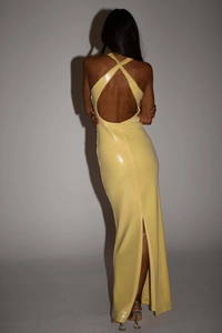 Detail of the yellow sequin evening gown showing a backless design and crossover straps