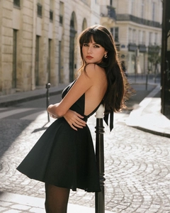 Elegant backless black halter dress with a large swing skirt in a European street setting