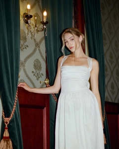 Detailed view of the elegant ruched bodice and square neckline on a white vintage dress