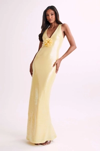 Detailed view of yellow sequin evening dress with waist flower applique and side slit
