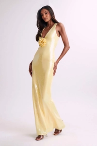 Detail of sequined long evening dress featuring handmade flower and plunging V-neck design