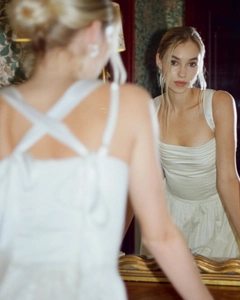 Detailed view of square neckline and pleated bodice on an elegant white satin dress