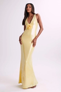 Detail of yellow sequin evening gown showing 3D floral applique and deep V-neckline
