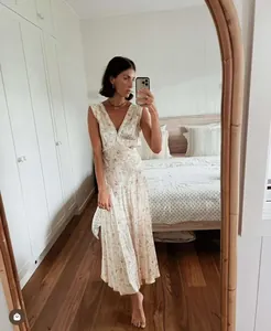 Close-up of French style V-neck floral dress with delicate lace trim and tie details