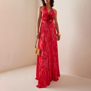 Elegant halter neck maxi dress with large 3D floral accent and red abstract pattern