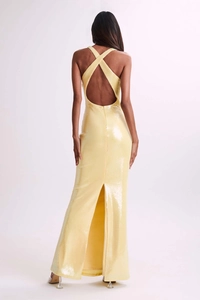 Detail of cross-back halter evening dress with shimmering yellow sequins and slit