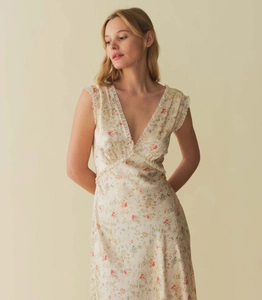 Close-up of elegant V-neckline with delicate white lace trim on floral print midi dress