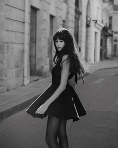 Artistic black-and-white street photography of a black backless dress in A-line silhouette