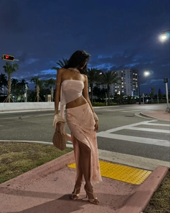 Detail of pink sequin maxi skirt with high slit and sheer halter neck top for vacation