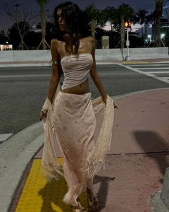 Detail of sequin long skirt and tube top with fringe shawl in outdoor night setting