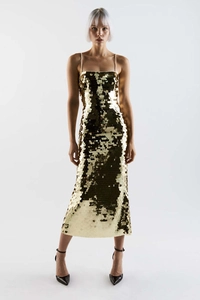 Macro shot of dense gold sequins on a glamorous evening dress with a metallic finish