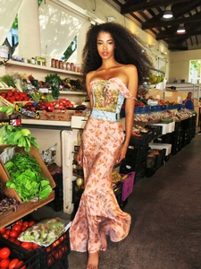 Detailed close-up of a floral print satin maxi dress with a vintage tapestry bustier design