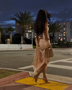 Pink sequin dress detail with sparkling texture and decorative fringe tassels