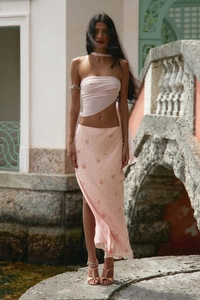 Detail of pink sequin maxi skirt with high slit and floral patterns for beach vacation