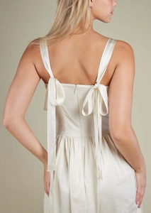 Detail of elegant satin dress back with tie-up bow straps and invisible zipper closure