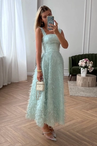 Detailed view of light blue maxi dress featuring textured feather fabric and square neck