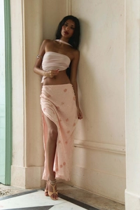 Detail of pink long skirt featuring 3D floral embroidery, sequins, and a high side slit