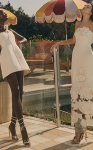 Detailed view of white strapless dresses with elegant 3D floral embroidery and lace